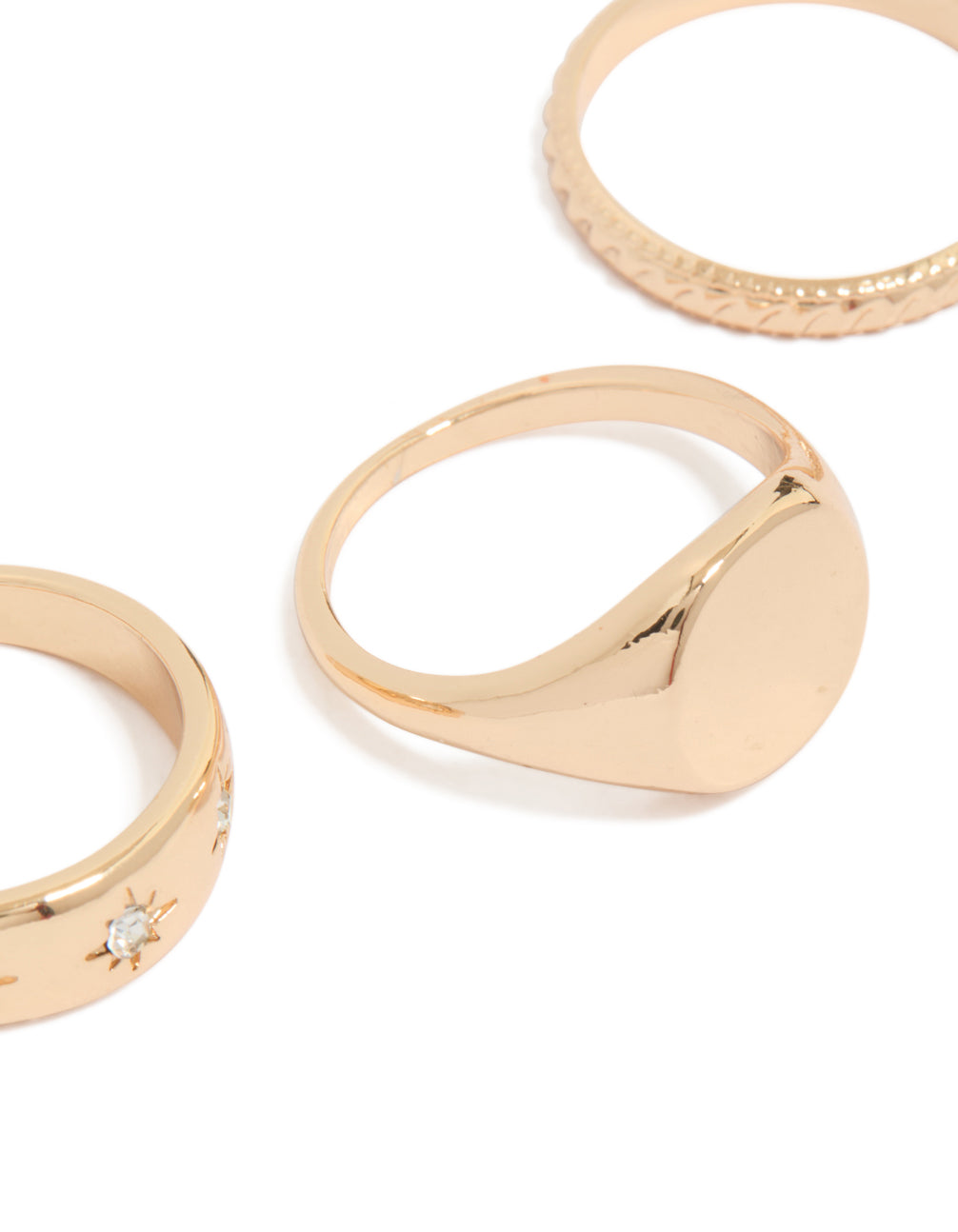 Crafted from gold featuring celestial star details and signet styling in a 3-pack close up view