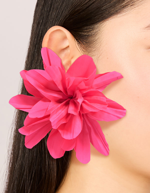 Featuring statement floral fabric flower petal earrings in gold and pink on ear view