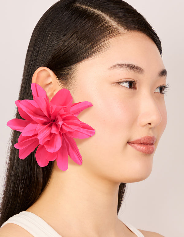 Crafted with statement floral fabric flower petal earrings in gold and pink on model view