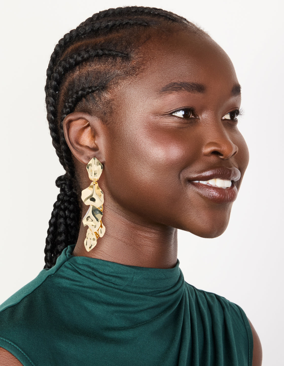 Styled statement multi petal drop earrings in gold plated finish on model view