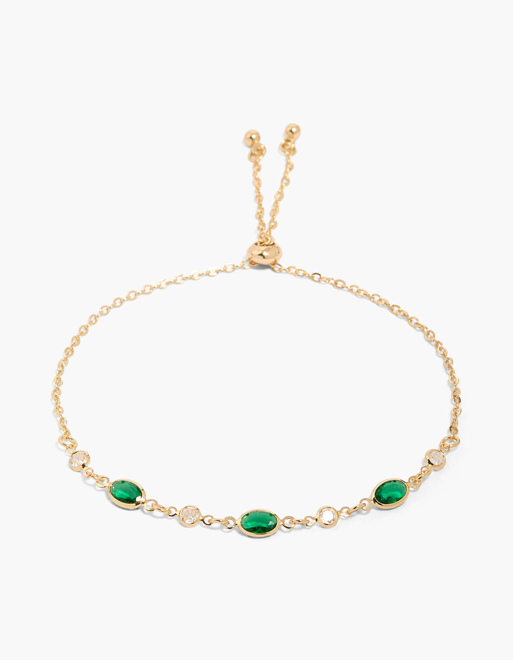 Showcasing a gold plated toggle bracelet with emerald and oval cubic zirconia front view