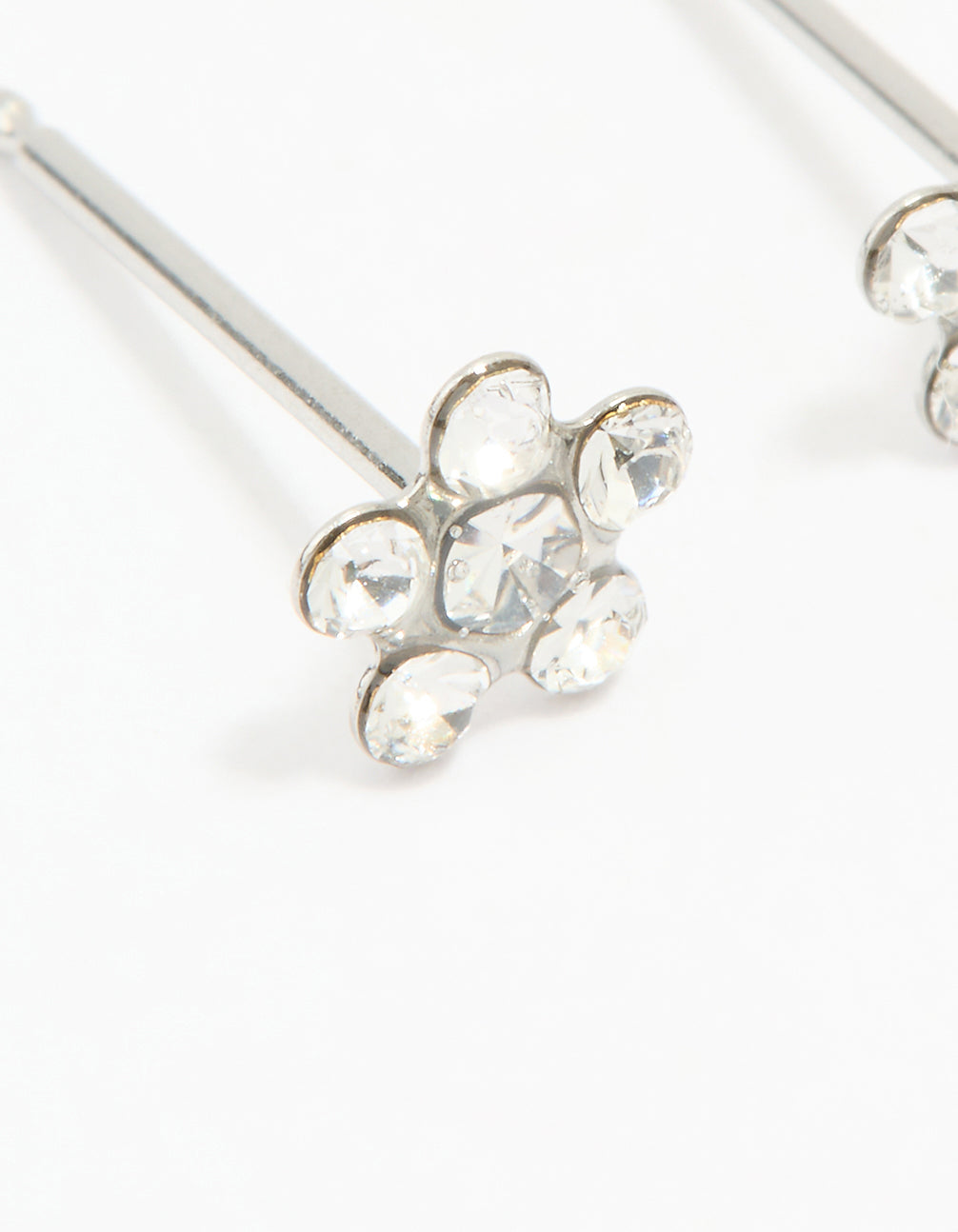 Beautifully crafted dainty surgical stainless steel cubic zirconia daisy piercing studs in silver and clear close up view