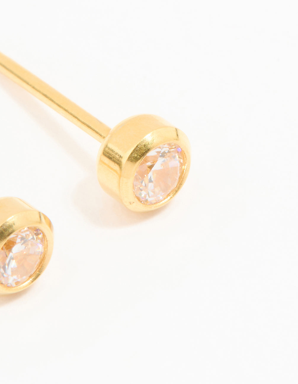 Showcasing 24K gold plated surgical stainless steel 3MM cubic zirconia bezel piercing studs with crystal design and stud closure close up view