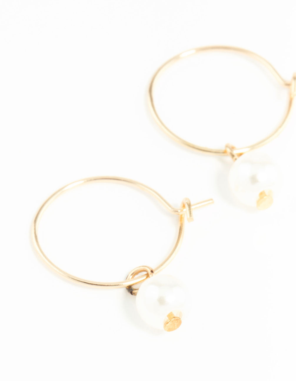 Showcasing dainty hoop earrings 3mm in gold with pearl close up view