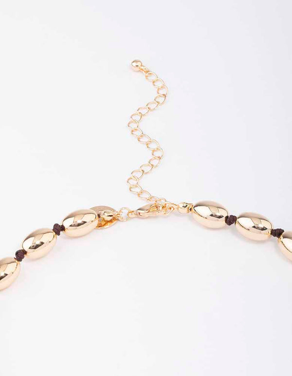 Gold Oval Bead Graduating Cord Necklace