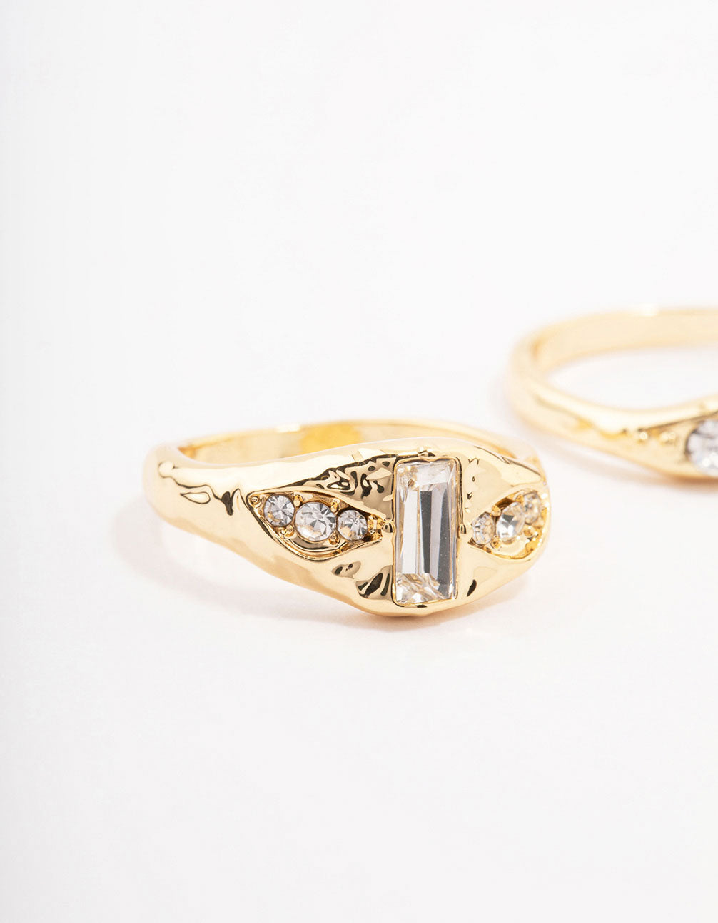 Featuring gold plated baguette signet stacking ring pack with cubic zirconia close up view
