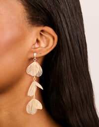 Crafted from gold lazercut petal drop earrings with floral detailing on ear view - link has visual effect only
