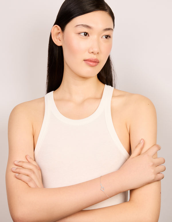 Stylish sterling silver infinity and cubic zirconia heart link bracelet in silver on model view