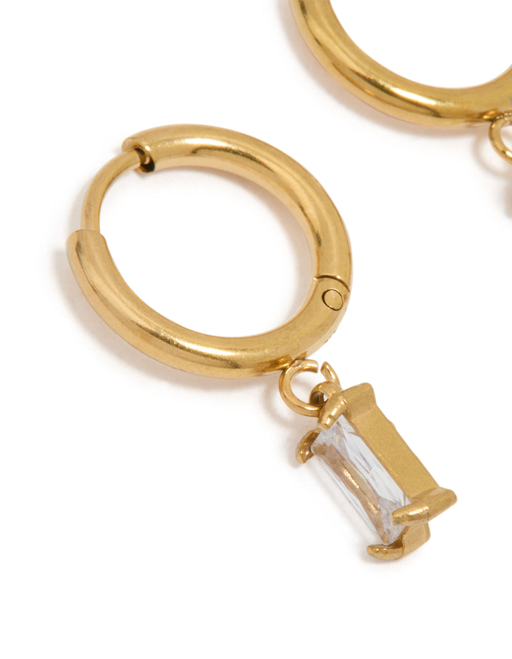 Highlighting waterproof gold plated stainless steel baguette diamante huggie earrings close up view