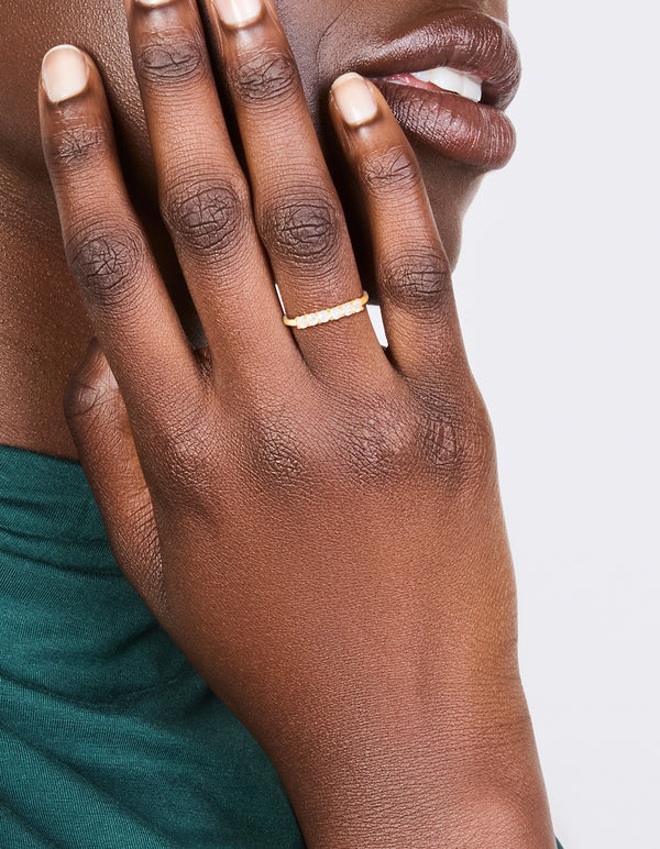 Elegant gold plated sterling silver ring with cubic zirconia in dainty style on finger view