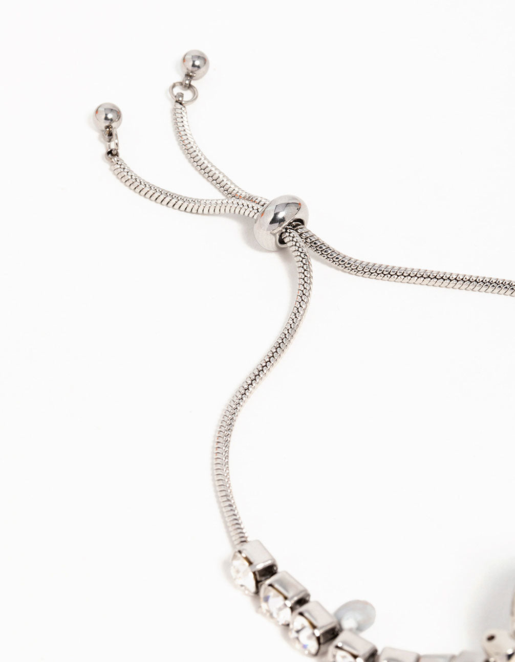 Refined women's analog bolo watch showcasing a clear stone-look round dial with link band strap in silver for casual occasions closure detail view