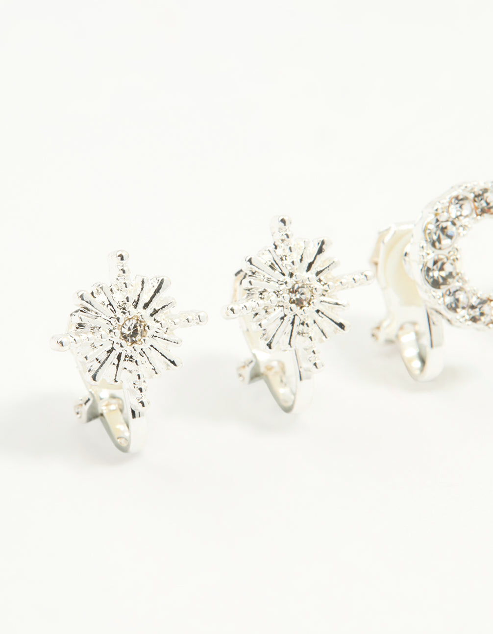 Explore silver star and moon clip-on earrings 4-pack with celestial designs in clear close up view