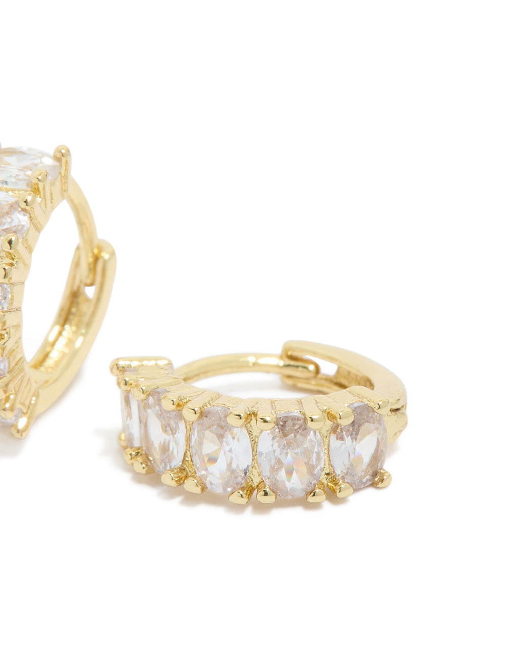 Highlighting gold plated cubic zirconia oval huggie earrings with clasp mechanism and prong details in clear and gold post detail view