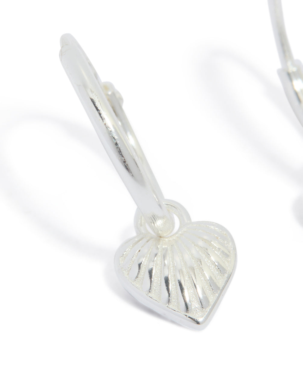 Designed with sterling silver heart huggie earrings in silver close up view