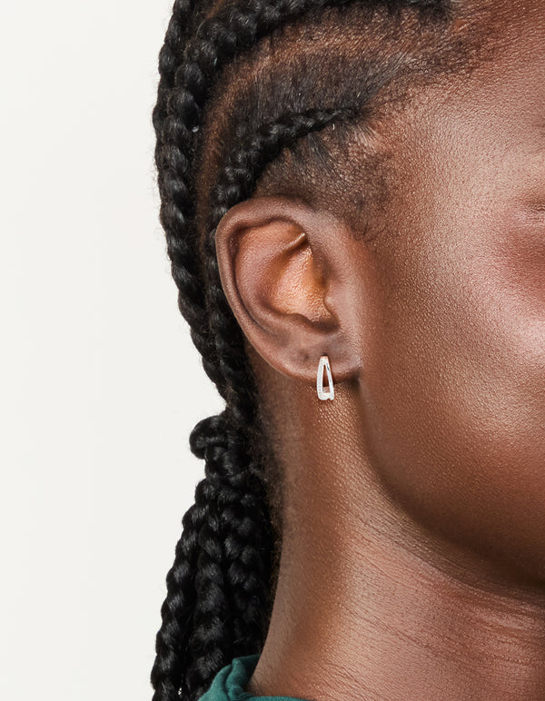 Featuring sterling silver cubic zirconia double hoop earrings with closure in silver on ear view