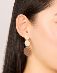 Showcasing gold molten and brown stone round drop earrings with statement style on ear view - link has visual effect only