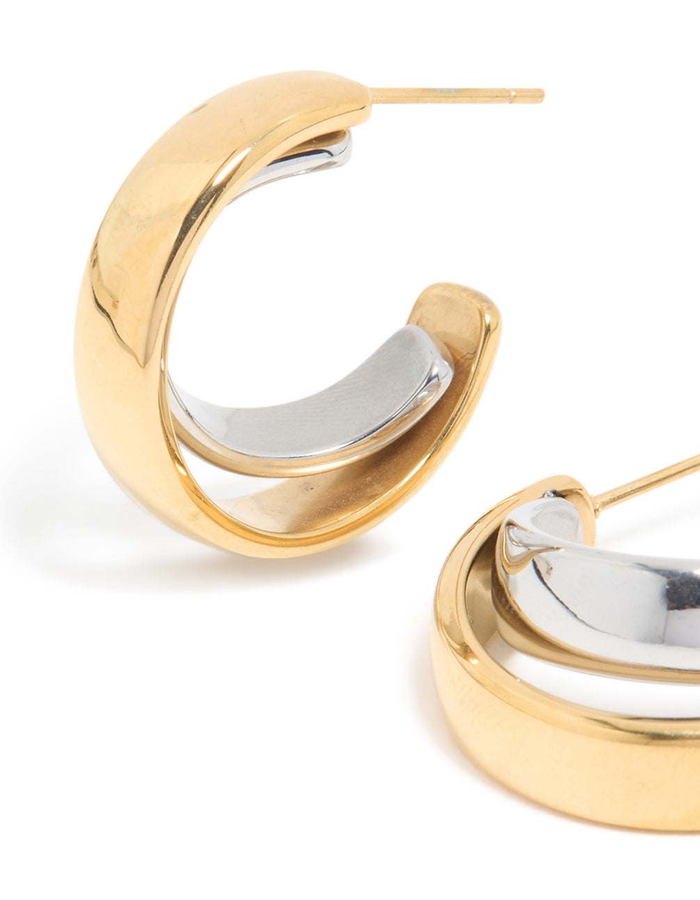 Showcasing waterproof mixed metal plated stainless steel smooth circle open hoop earrings in statement style with gold and silver colors close up view