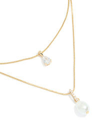 Showcasing a gold plated cubic zirconia pearl layered necklace close up view - link has visual effect only