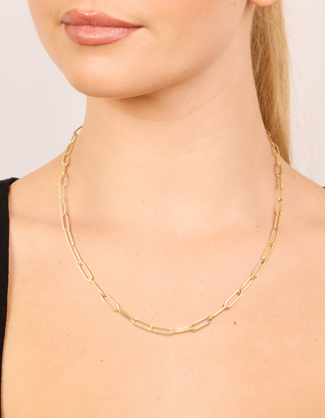 Designed with waterproof gold plated stainless steel open oval link chain necklace in chunky style on neck view