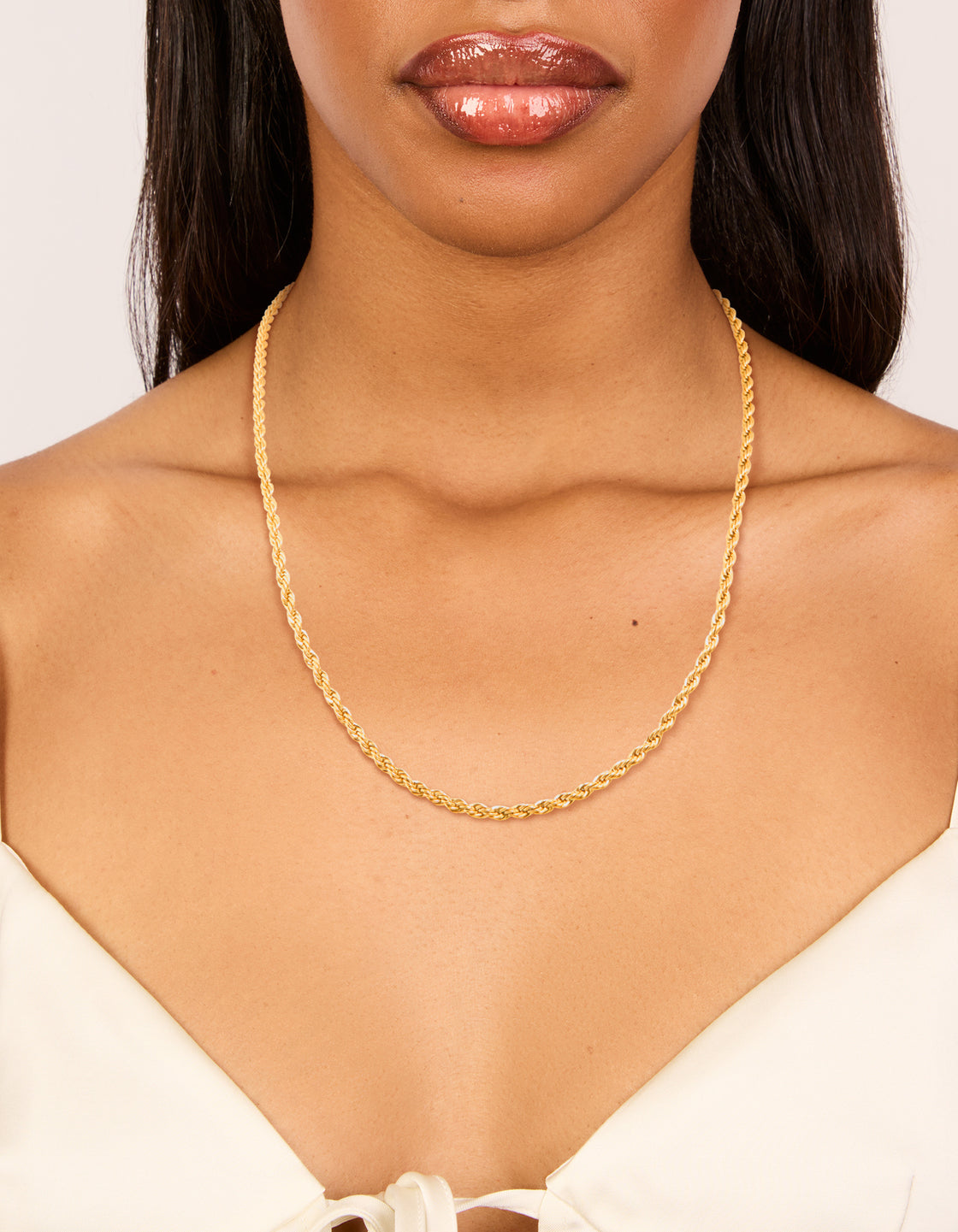 Beautifully displaying a waterproof twisted chain necklace in gold plated stainless steel on neck view