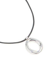 Featuring a waterproof organic pendant necklace crafted from stainless steel on a black cord close up view - link has visual effect only