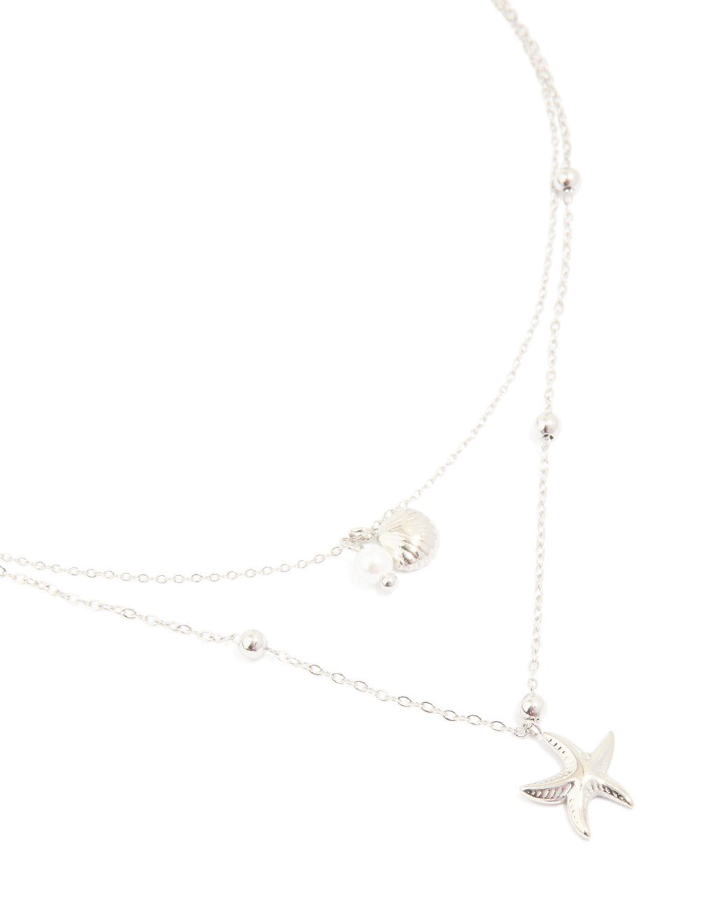 Showcasing a waterproof stainless steel starfish and shell layered necklace with balls, charm and pearl featuring ocean-inspired details in silver close up view