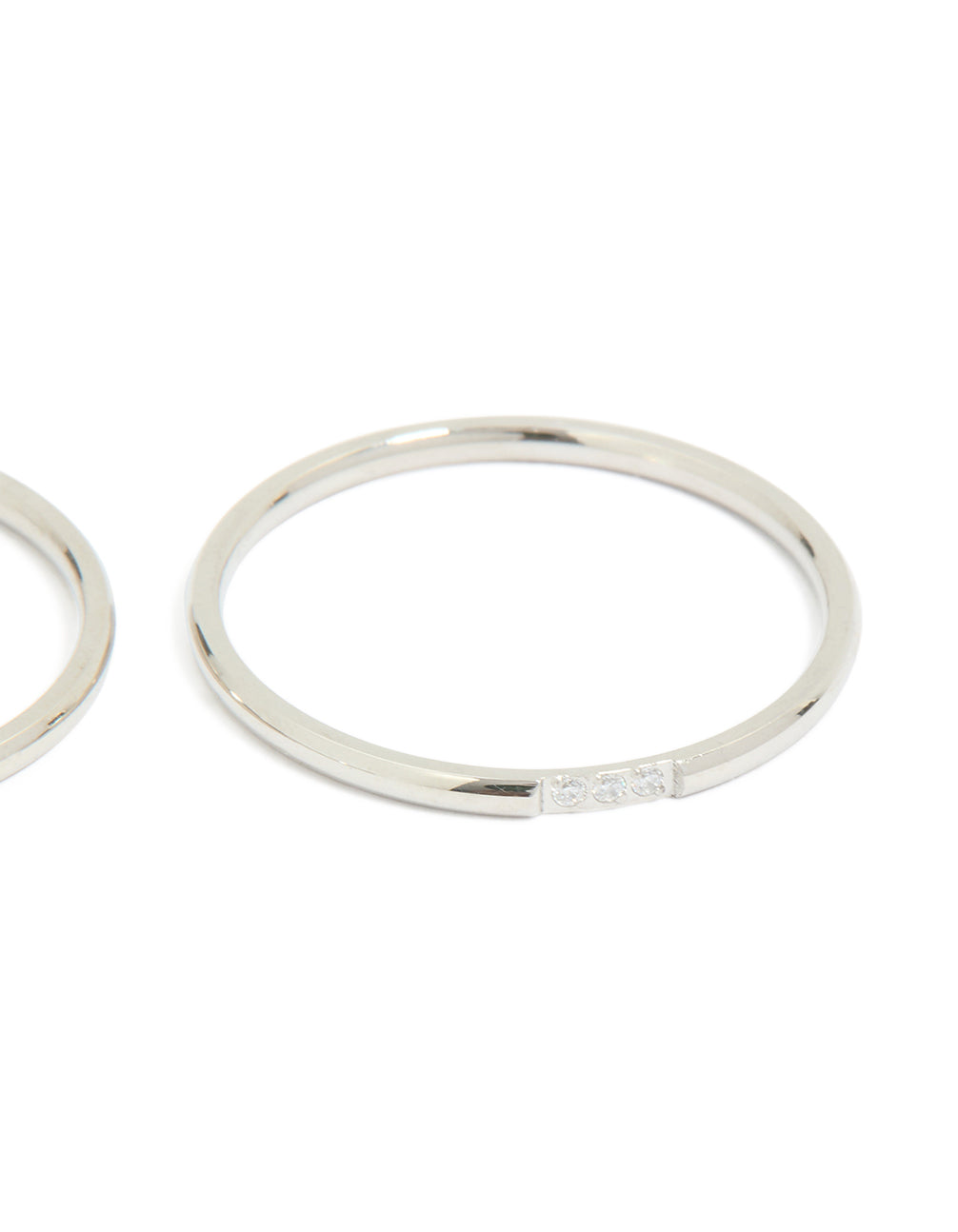 Highlighting waterproof stainless steel material, this thin cubic zirconia trio rings 3-pack in silver and clear stone side detail view
