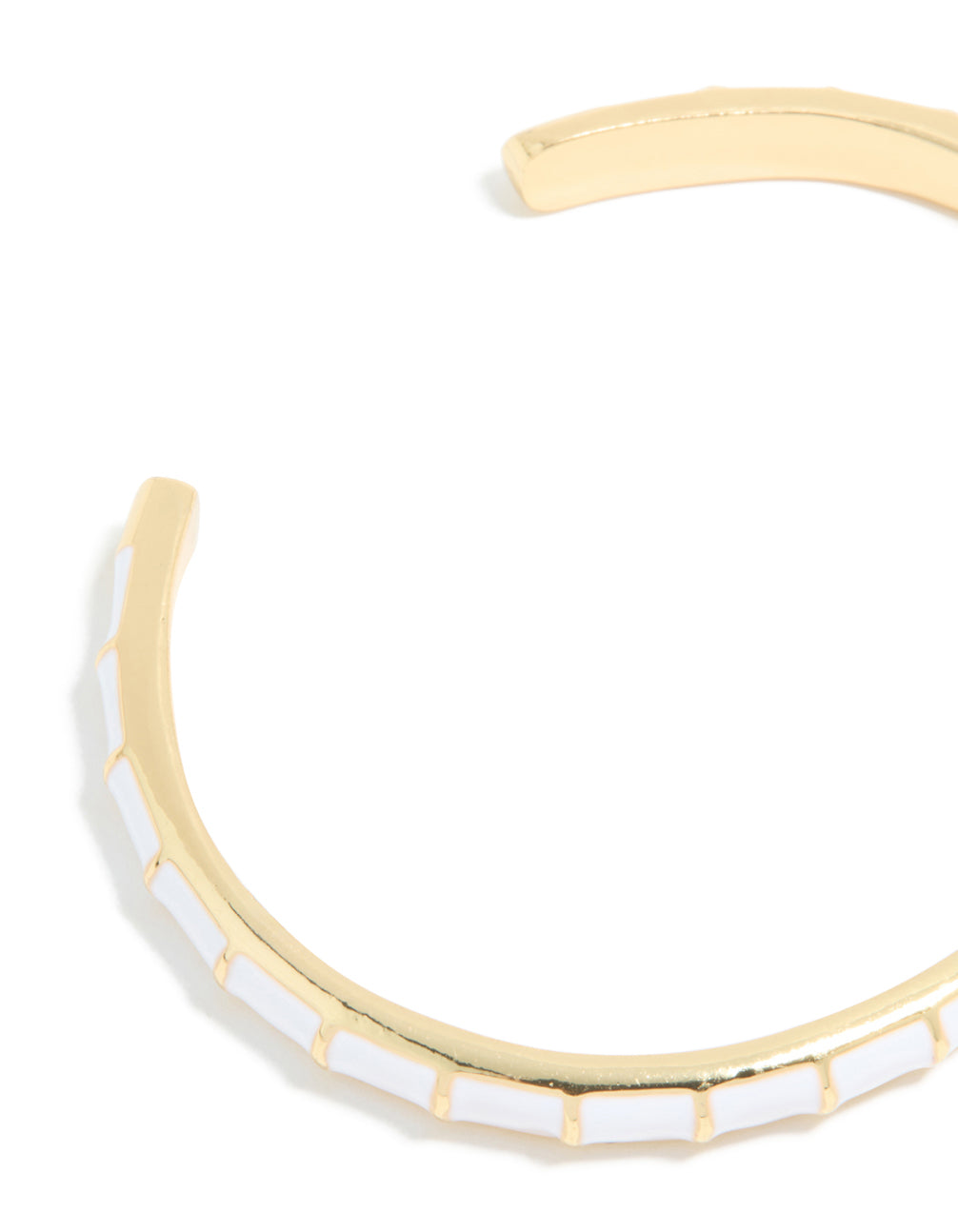 Displaying a waterproof cuff bracelet in stainless steel with white enamel bamboo detailing and gold plated construction closure detail view