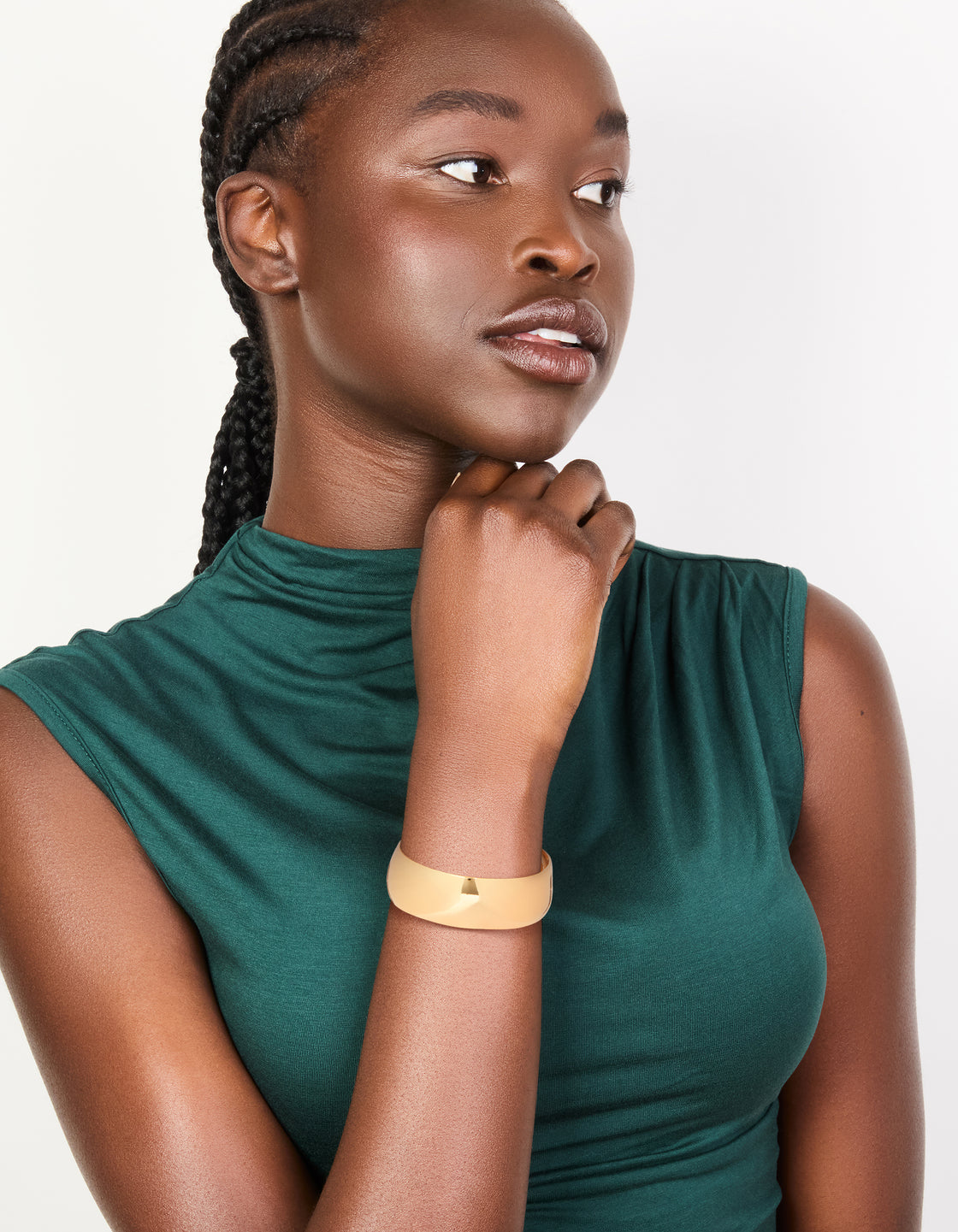 Highlighting a waterproof thick open wrist cuff crafted from stainless steel with statement styling in gold plated finish on model view