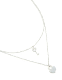 Showcasing a waterproof stainless steel layered necklace featuring key & heart and padlock pendant in silver close up view - link has visual effect only