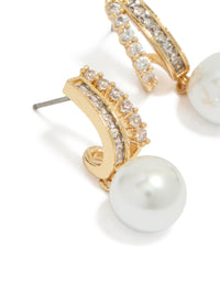 Featuring gold plated cubic zirconia illusion pearl drop earrings with hoop closure in white close up view - link has visual effect only