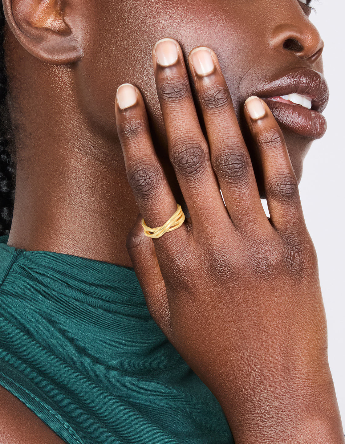 Showcasing a waterproof gold plated stainless steel crossed line ring with statement design on finger view