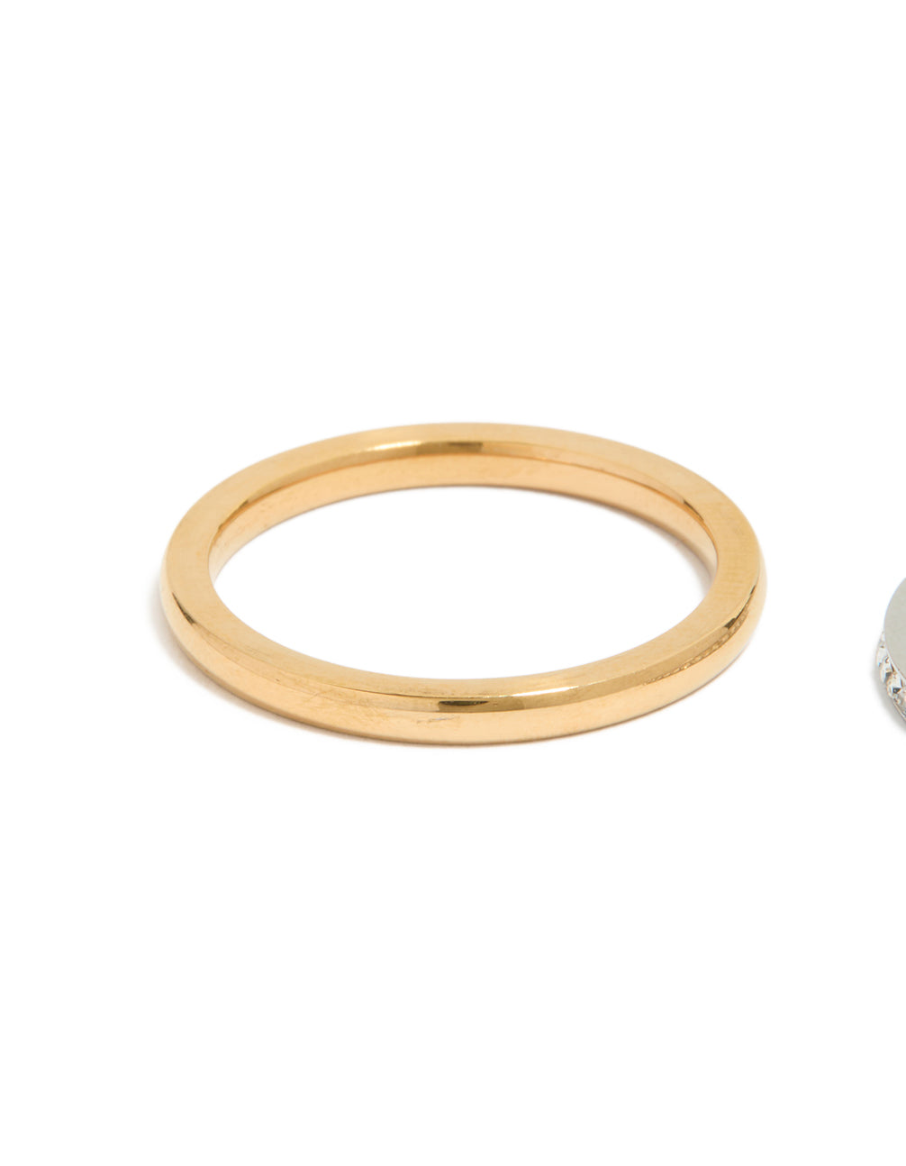 Detailed view of waterproof mixed plated thin stacking ring with cubic zirconia accents, made from stainless steel in gold tone side detail view