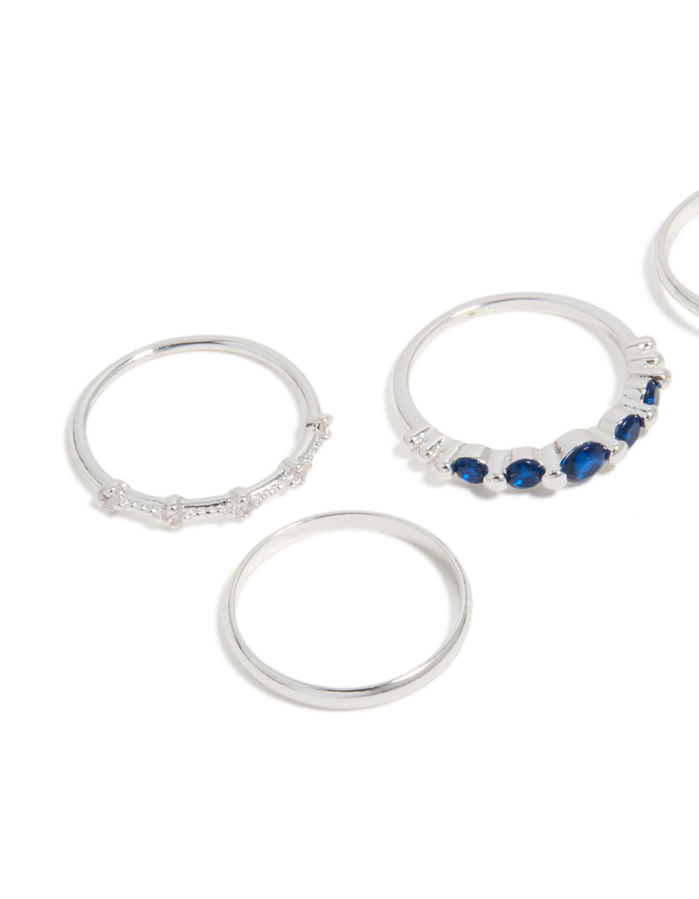Showcasing silver plated dainty cubic zirconia stacking rings 5-pack with royal blue and clear stones close up view