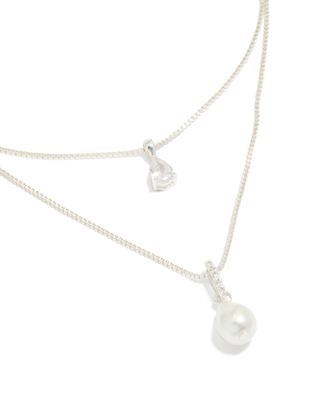 Discover a silver plated double layered cubic zirconia and pearl necklace close up view
