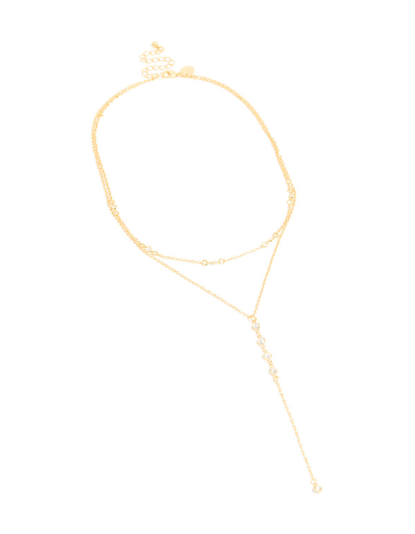 Discover this cubic zirconia bezel layered Y-necklace featuring ball details in gold plated finish with dainty statement design close up view