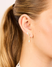 Showcasing dainty drop hoop and stud earrings in a 2-pack, crafted from cubic zirconia with gold plating on ear view - link has visual effect only