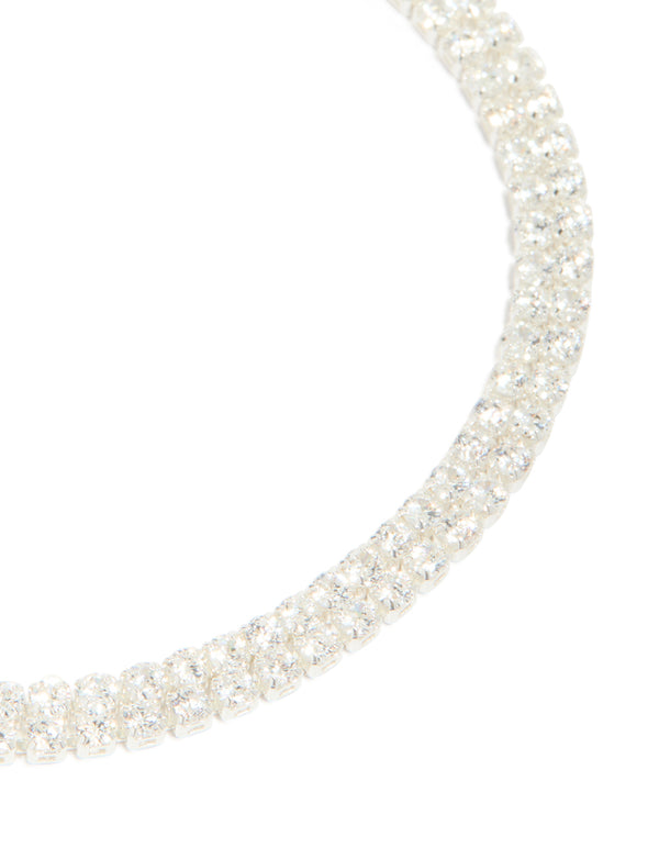 Crafted from silver plated cubic zirconia thin tennis layered toggle bracelet close up view