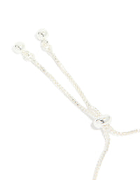 Presenting a silver plated cubic zirconia thin tennis layered toggle bracelet closure detail view - link has visual effect only