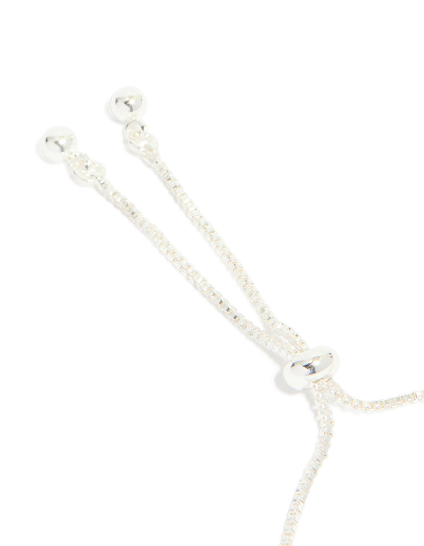 Presenting a silver plated cubic zirconia thin tennis layered toggle bracelet closure detail view