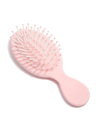 Compact light pink mini hair brush front view - link has visual effect only