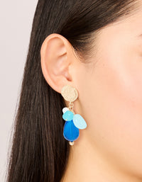 Showcasing gold textured and blue beaded drop earrings with charms featuring statement style on ear view - link has visual effect only
