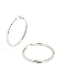 Showcasing surgical steel crossover hoop earrings in silver front view - link has visual effect only