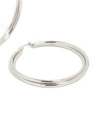 Featuring surgical steel crossover hoop earrings in silver post detail view - link has visual effect only