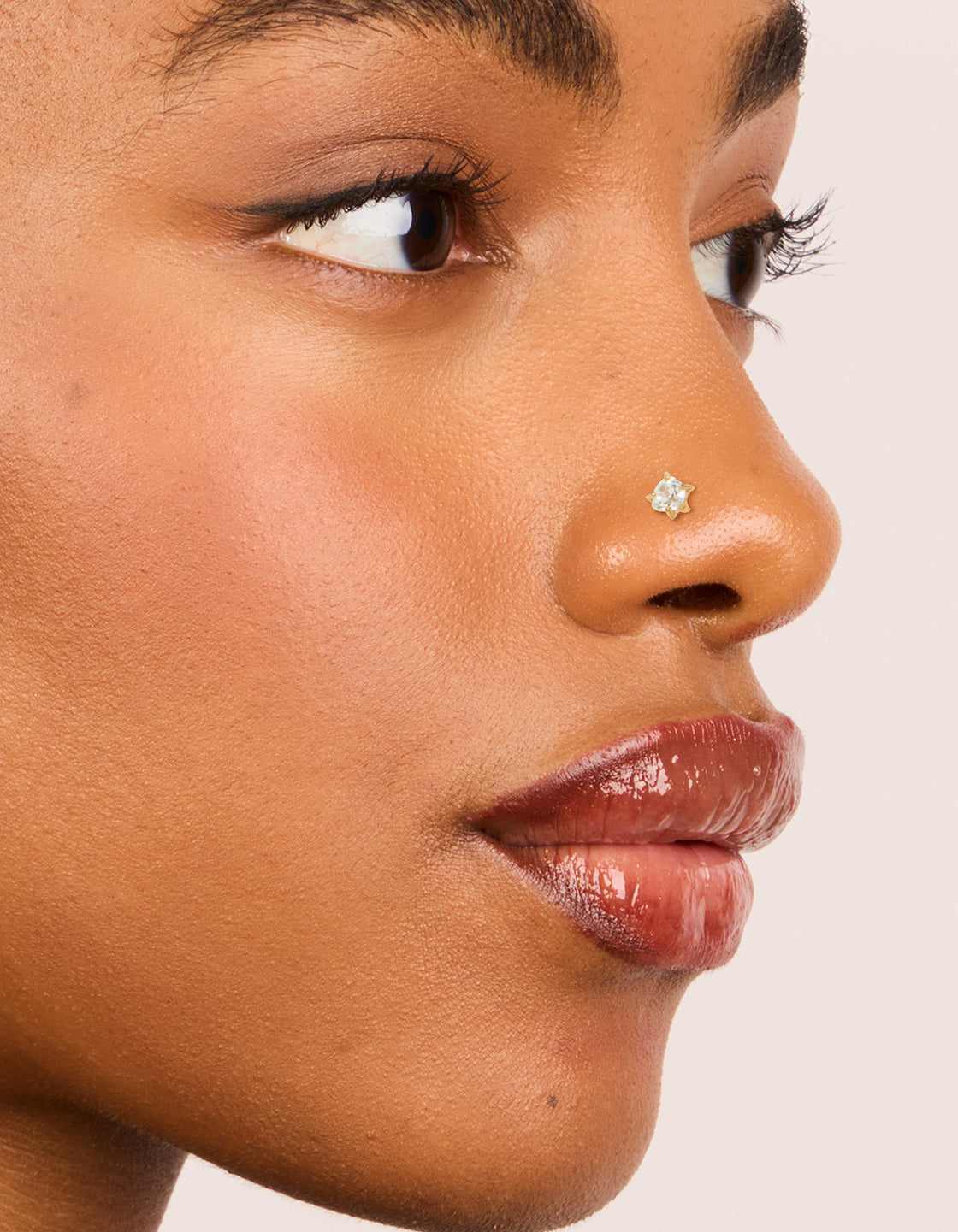 Showcasing gold plated titanium cubic zirconia threadless flat back nose stud nose view
