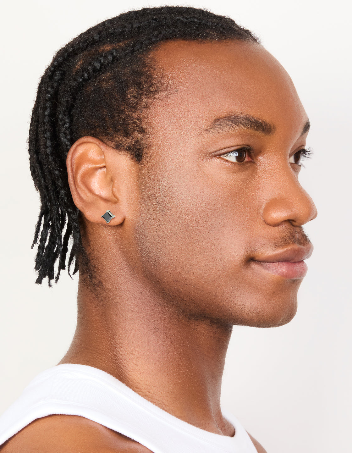 Designed with waterproof stainless steel and black cubic zirconia, these mens small square stud earrings are shown on model view