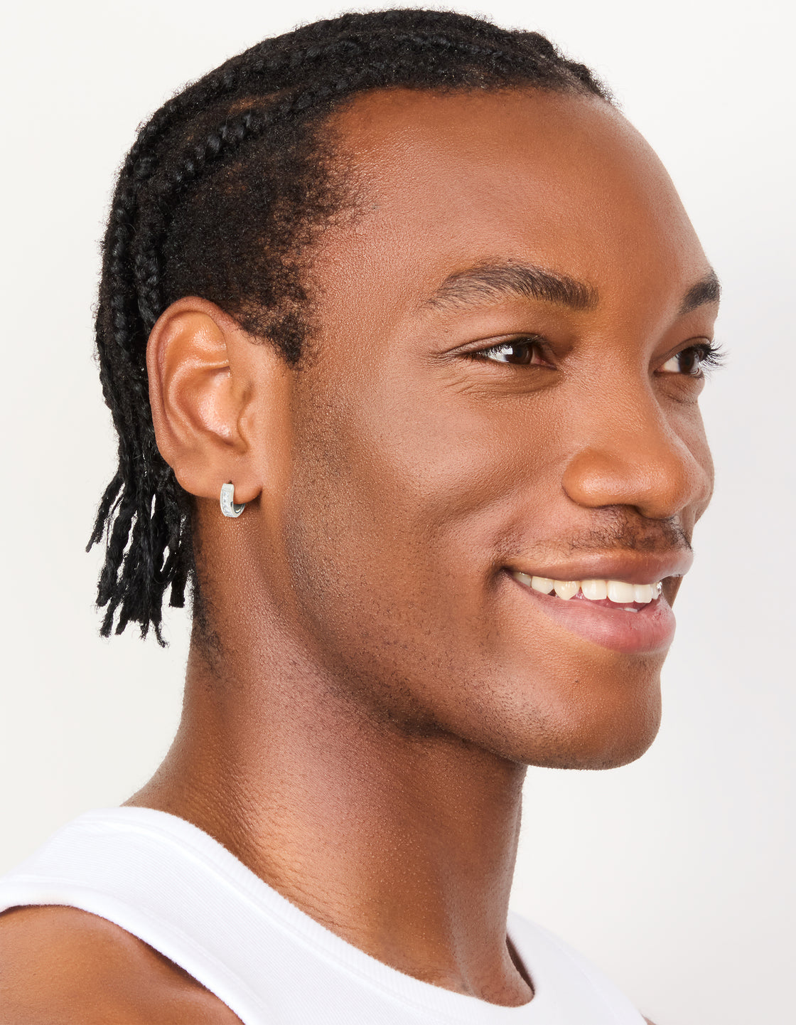 Showcasing mens waterproof stainless steel square cubic zirconia huggie earrings in silver on model view