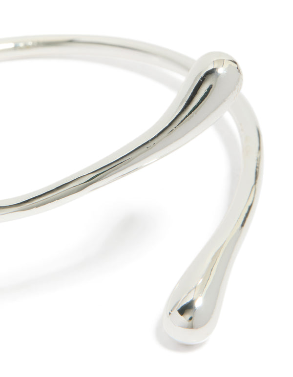 Stunning teardrop wrap around bangle crafted from silver plated material close up view
