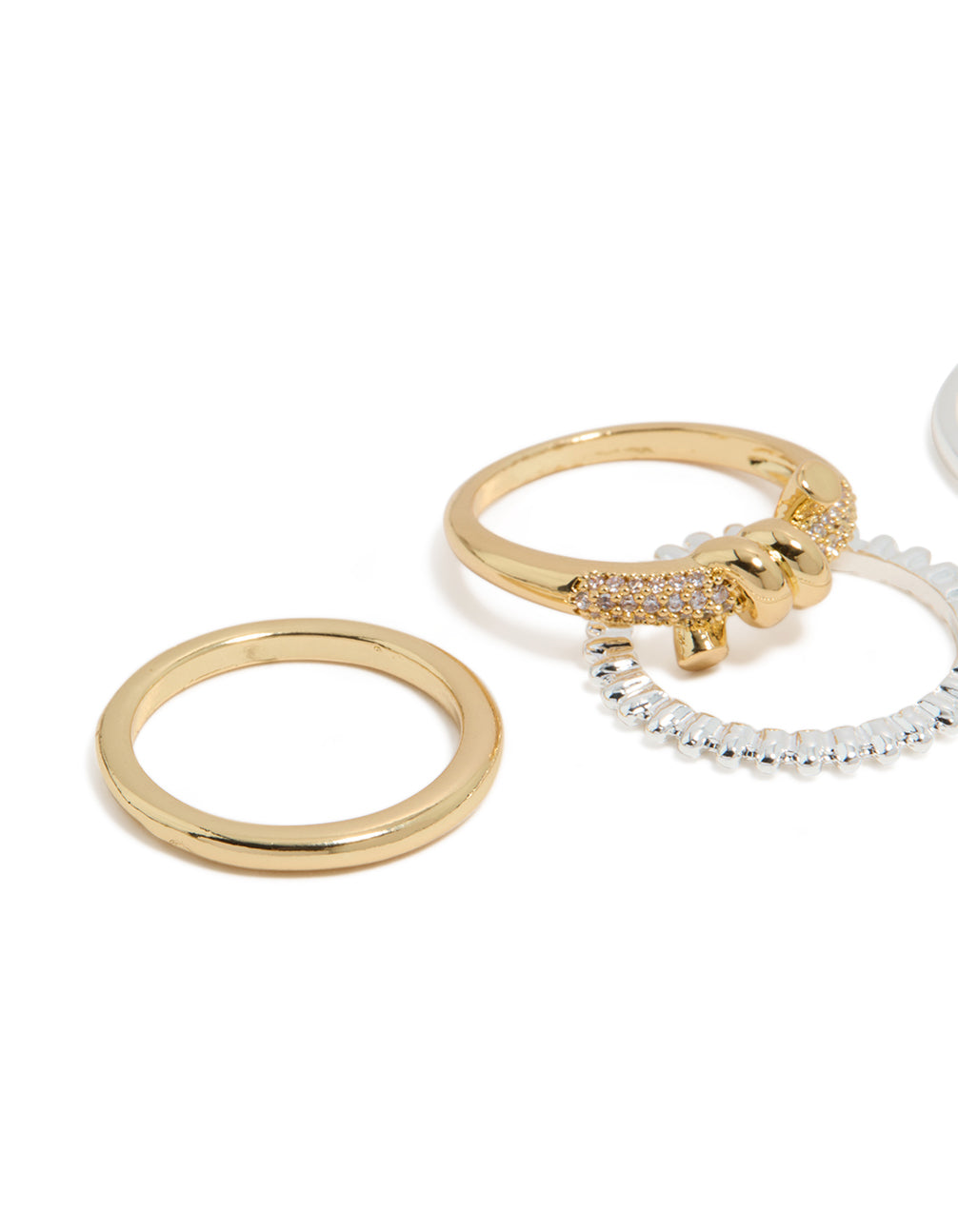 Crafted from mixed metal plated cubic zirconia, this knotted textured rings 4-pack in gold, silver, and clear stone side detail view