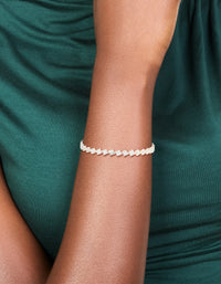 Showcasing a silver plated cubic zirconia multi flower tennis bracelet with floral pattern on wrist view - link has visual effect only